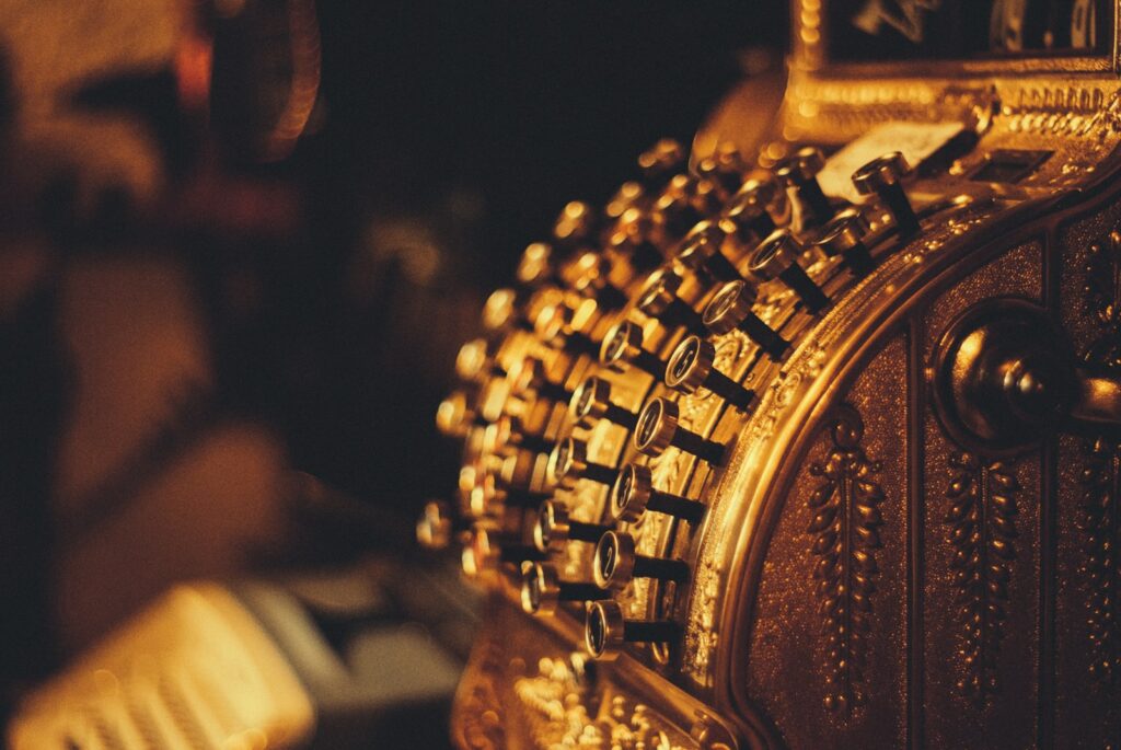 closeup photography of gold-colored ornament-historical value of gold