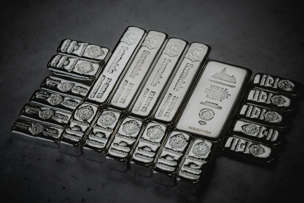 a pile of silver bars sitting on top of a table silver bar