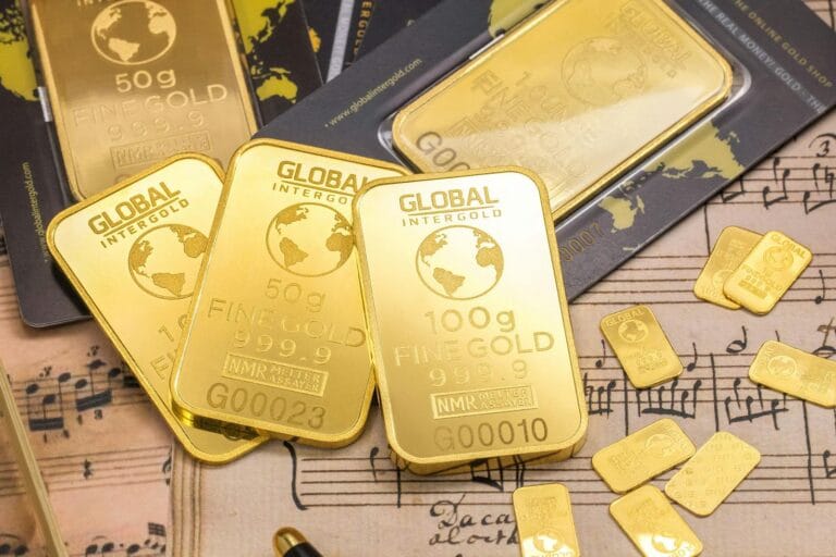 Gold bars stacked on sheet music, showcasing wealth and luxury with fine detail.Gold Bullion